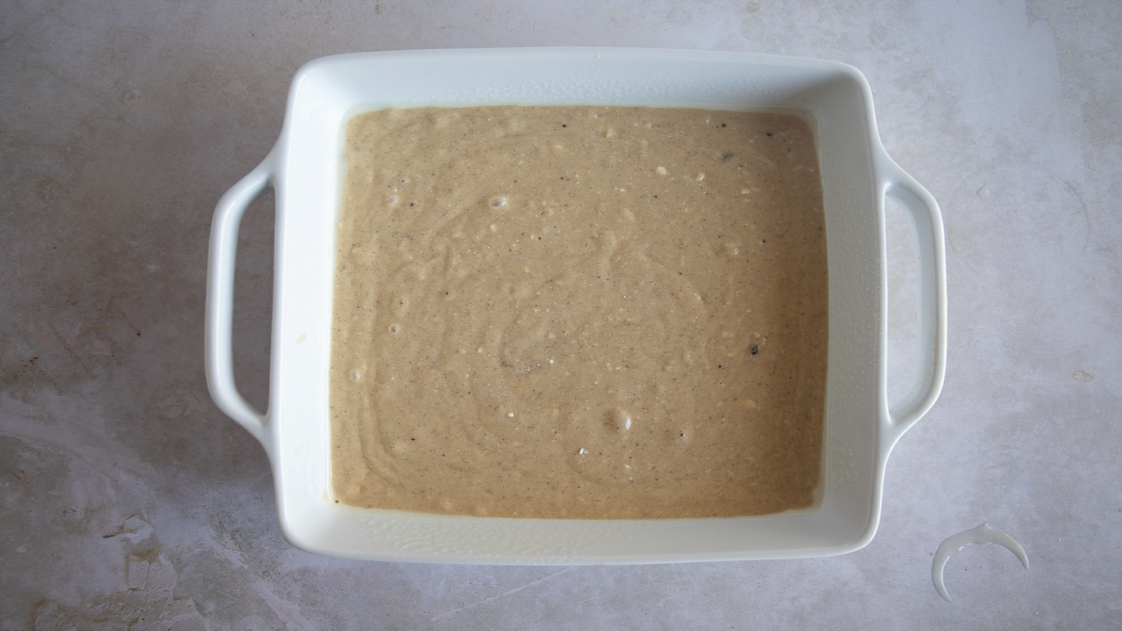Cookies 'N Cream batter spread out in a pan.
