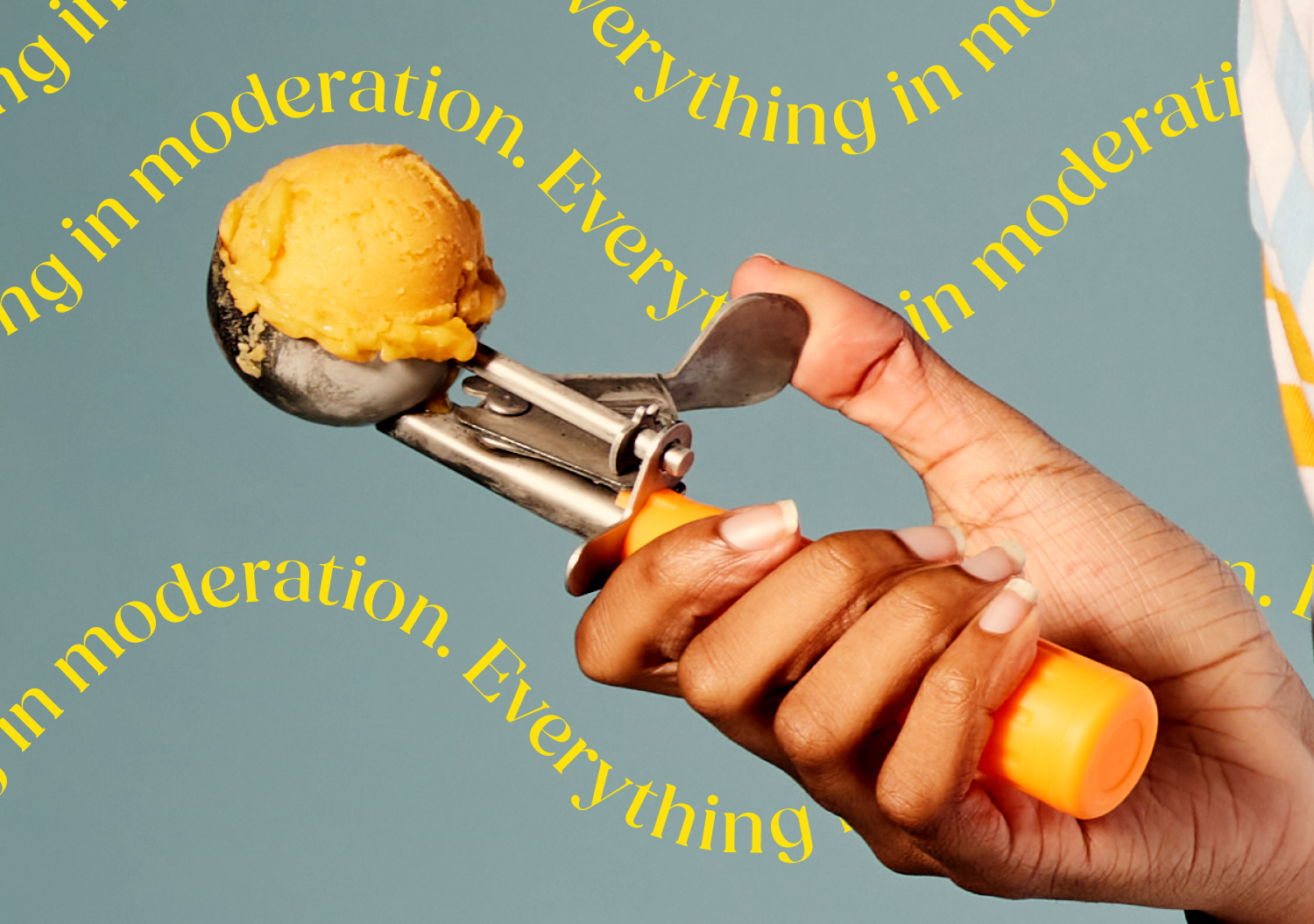 A closeup of an ice cream scooper over flowing with ice cream. 