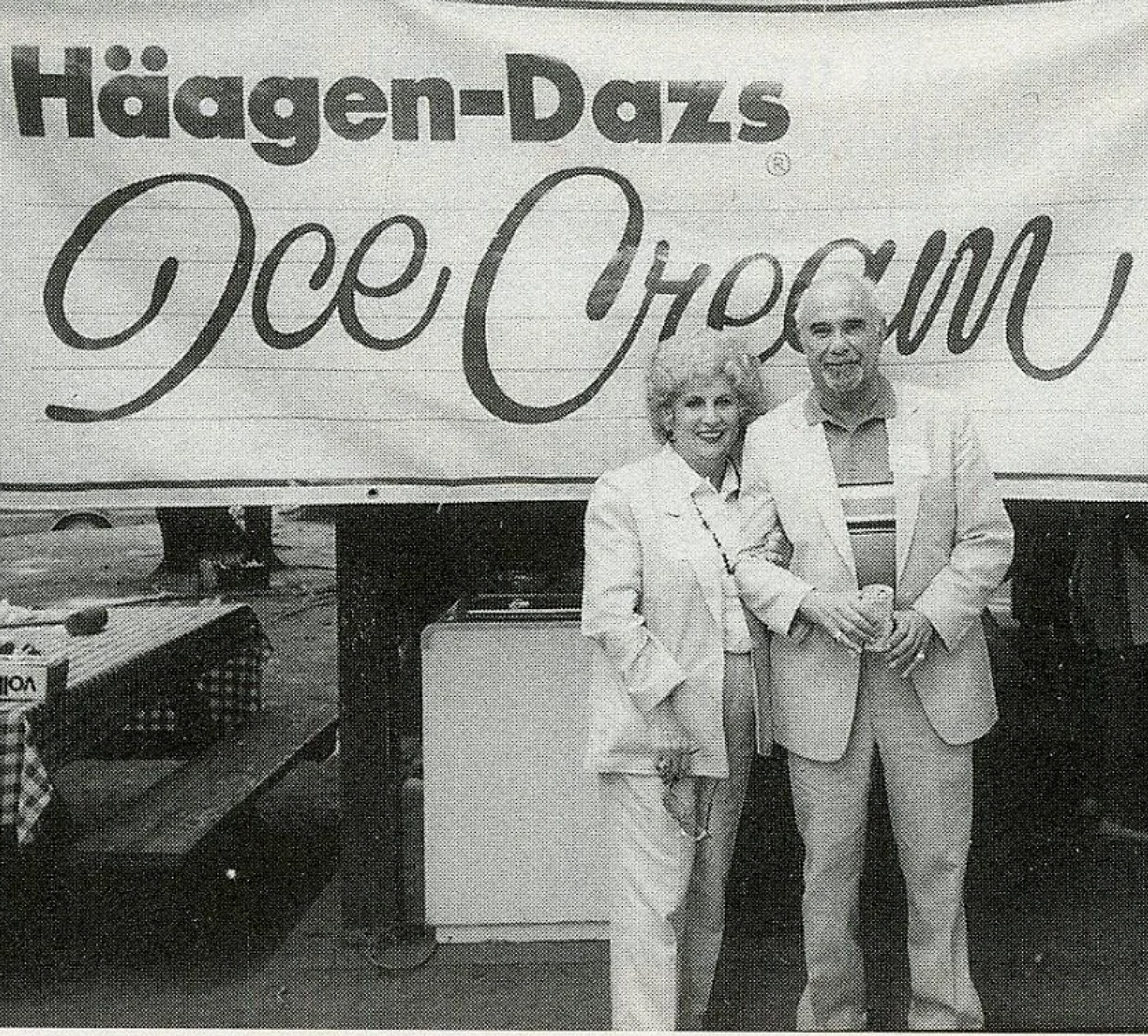 William Dreyer and his wife standing in front of a Haagen-Dazs ice cream sign.