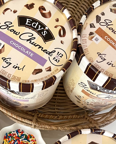 A basket with two containers of Edy's frozen dairy dessert. 