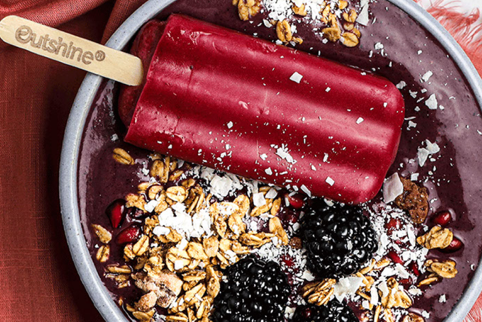 Pomegranite Acai bowl topped with an Outshine Frozen Fruit Bar. 