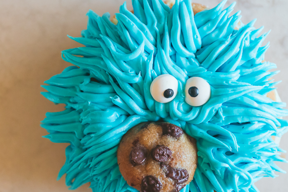 Donut ice cream sandwiches decorated to look like Cookie Monster. 