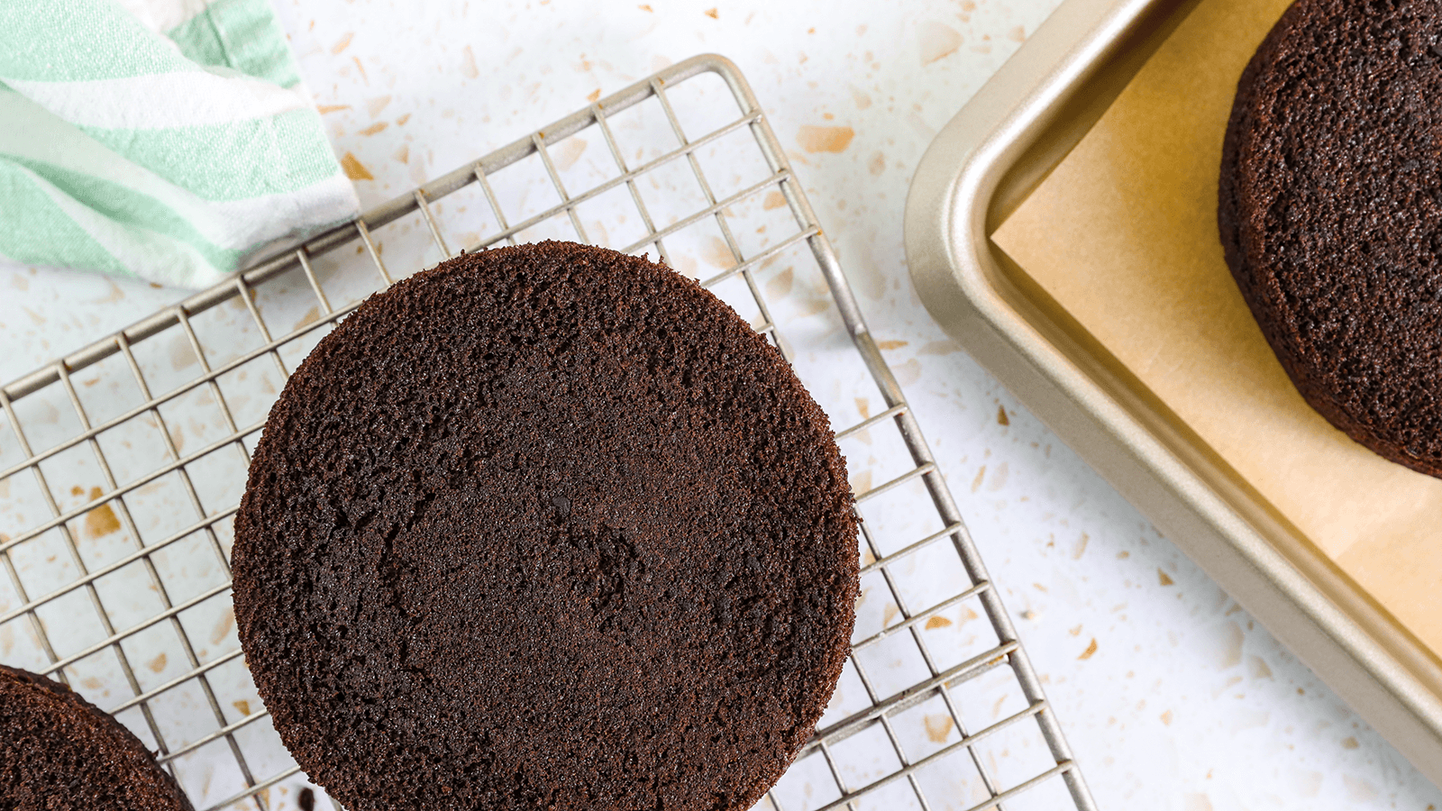 Chocolate cake on a cooling rack.
