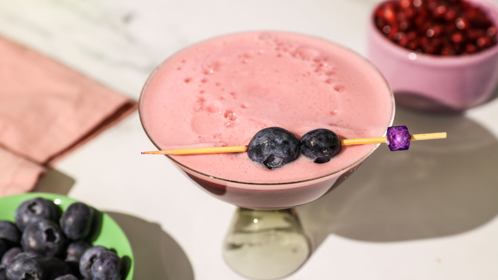 Finished witches brew halloween mocktail with blueberries on top.