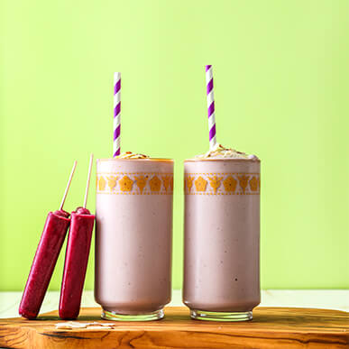 Outshine grape almond butter smoothie with a straw